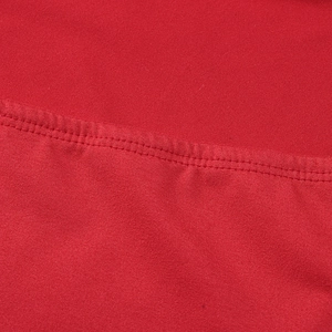 Detailed close-up of high-quality red knit fabric with durable double-stitch sewing