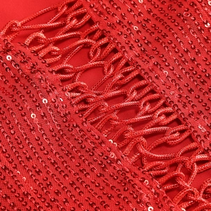 Macro detail of red sequins and woven rope texture on a formal slit evening dress