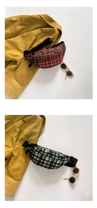 Close-up of kids canvas waist bags featuring red and green plaid patterns and buckles