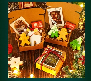 Macro view of Christmas candle set with gingerbread man and tree in festive gift box