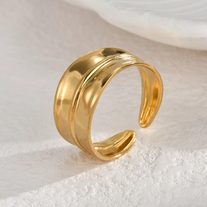 Modern wide gold stainless steel open ring with a polished surface and center ridge