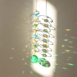 Detail of 3D spinner with colorful crystal beads casting rainbow light on a wall