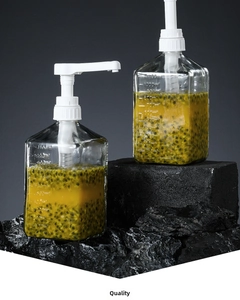 Detail of 1100ml square glass syrup bottle with volume scale and white pump head