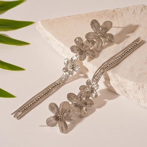 Detailed view of vintage silver floral tassel earrings with sparkling rhinestones