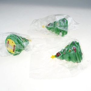 Three green wind-up Christmas tree toys in clear plastic bags on a white background
