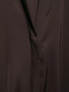 Close-up of dark brown satin fabric texture and premium V-neck stitching details