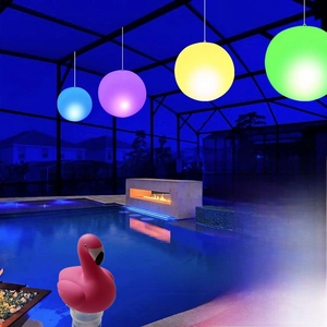 Waterproof LED inflatable Christmas ball lights floating in a pool at night