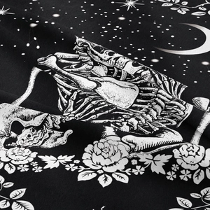 Bohemian skull and floral tapestry with white moon and star patterns on black fabric