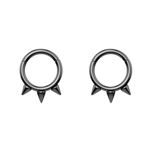 Detail view of black stainless steel circular rings with three spikes for septum or ear
