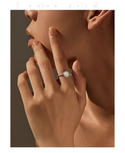 Detailed view of an S925 silver ring featuring a white opal center and pavé diamond halo