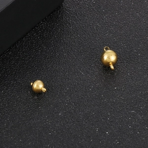 Detailed view of polished gold magnetic ball clasps for DIY jewelry necklaces and bracelets