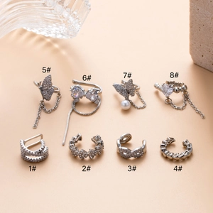 Silver cartilage ear clips with zircons and butterfly designs in eight various styles