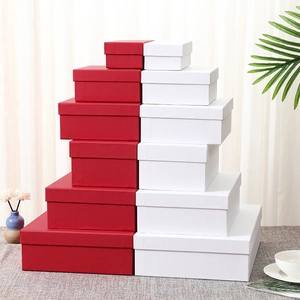 Stack of white and red luxury paper gift boxes in various sizes for stylish packaging