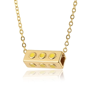 Fashionable gold link necklace featuring a creative rectangular block pendant with yellow dots