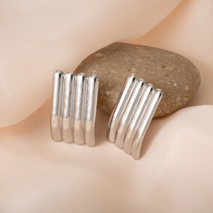 Minimalist silver vertical striped earrings displayed on a pebble with pink silk fabric