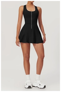 Detail view of a black athletic tennis dress featuring a functional front zipper closure