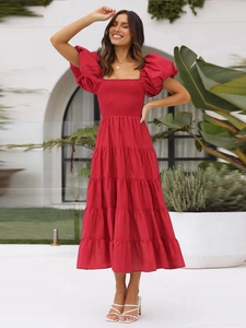 Detail of red off-shoulder puff sleeve dress featuring a ruched bodice and tiered skirt