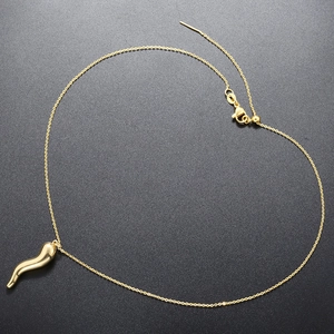 Detail of 18K gold plated S-shaped pepper pendant on delicate O-chain necklace