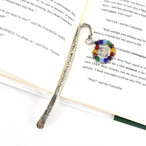 Handmade silver metal bookmark with seven colorful chakra stone beads in open book