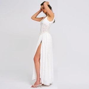 Close-up detail of white lace texture and high slit design on a backless maxi dress