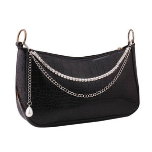 Detail of black faux crocodile leather bag with silver metal chain and pearl pendant