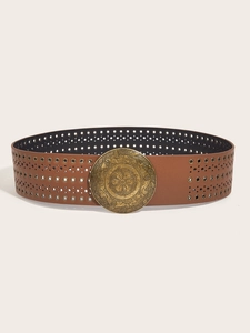 Macro detail of brown leather belt with metal eyelets and vintage engraved round buckle