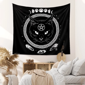 Detail of celestial cat tapestry hanging as wall decor in a bohemian style bedroom