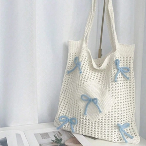 Minimalist white knit tote bag with blue ribbons and openwork crochet design for women