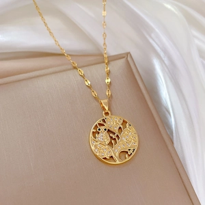 Elegant gold titanium steel tree of life necklace with a crystal owl pendant on white silk