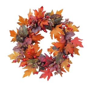 Autumn harvest wreath with faux maple leaves and berries on a clean white background