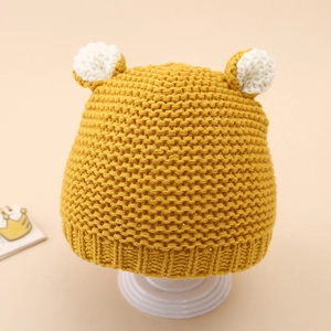 Detail of ginger knit baby beanie featuring cute white 3D ears and ribbed texture