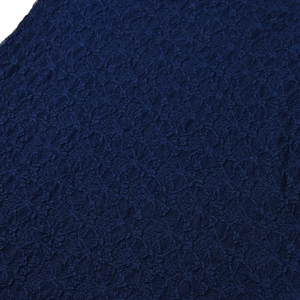 Close-up of navy blue lace fabric showing intricate geometric floral patterns and mesh detail