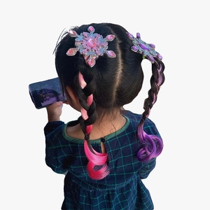 Detail of girl wearing snowflake hair clip with pink and purple gradient braided wig
