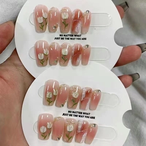 Handmade press-on nails with pink gradient blush design and 3D tulip floral patterns