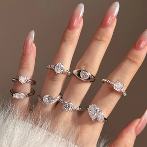 Stackable S925 silver rings with heart and oval zircon stones on model's hand