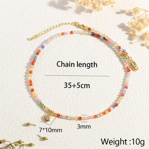 Detailed view of bohemian colorful beaded necklace with golden sun pendant and measurements