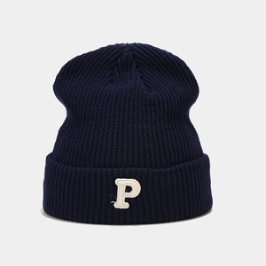 Detailed view of navy blue ribbed knit beanie with white towel-embroidered P letter