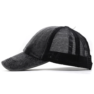 Detail of washed denim baseball cap with breathable black mesh back and adjustable strap