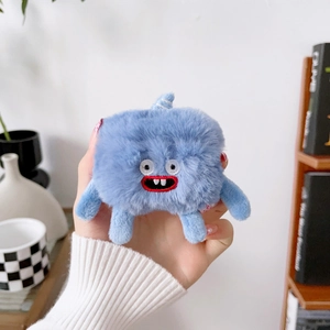 Detail of blue plush monster earphone case with embroidery and 3D limbs for AirPods