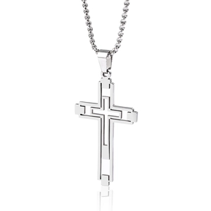 Macro detail of a silver stainless steel hollow-out cross pendant with studio reflections