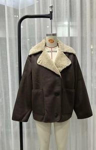 Close-up of brown faux shearling jacket with white faux fur collar and large pockets