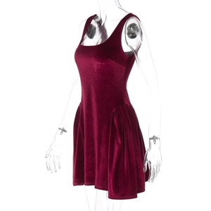 Detail view of burgundy velvet sleeveless dress showing waist pleats and fabric texture