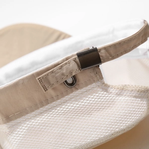 Detail of adjustable strap with metal buckle and breathable mesh on khaki military cap