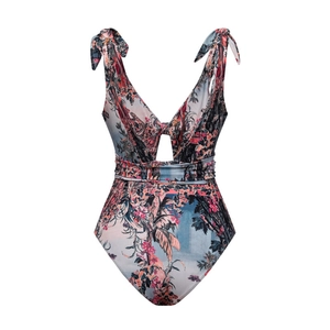 Detail of V-neck one-piece swimsuit featuring tropical prints and shoulder bow ties