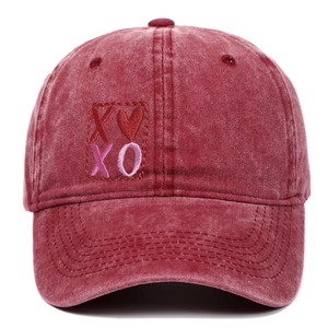 Detail of XO heart embroidery patch on vintage washed burgundy cotton baseball cap
