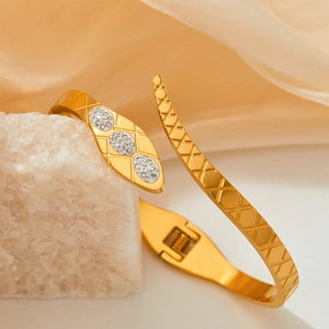 Exquisite gold snake bangle with sparkling crystal inlay on silk background fabric