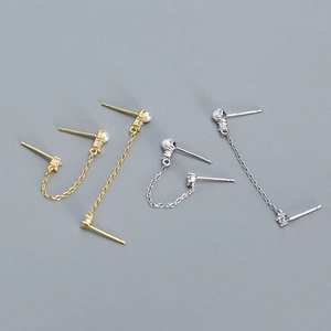 Detail view of pearl and diamond tassel earrings in gold and silver finishes