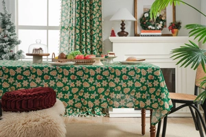 Detailed view of green Christmas gingerbread man pattern on high-quality fabric tablecloth