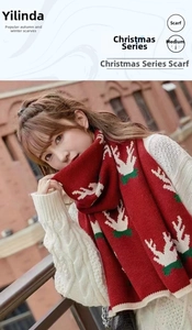 Detail shot of the reindeer jacquard knit pattern on this red Christmas cashmere-feel scarf