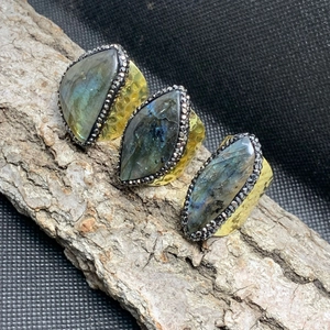 Adjustable golden hammered ring with marquise cut labradorite stone and micro-pave crystals